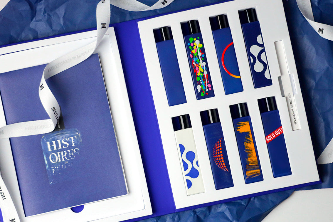 Histoires de Parfums Blue Book set opened, showcasing eight 15ml bottles from the This is not a blue bottle collection arranged on a white insert with a pack of blotters